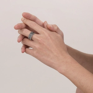 Retro punk style leaf ring in vintage silver finish shown on a male hand