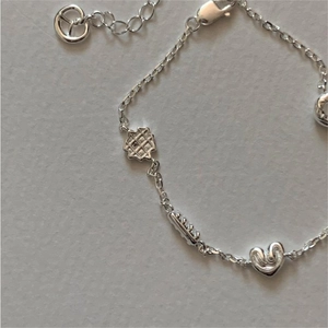Minimalist S925 sterling silver bracelet with waffle and heart charms on a sleek chain