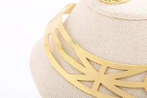 Detailed close-up of golden metallic star collar with geometric hollow design