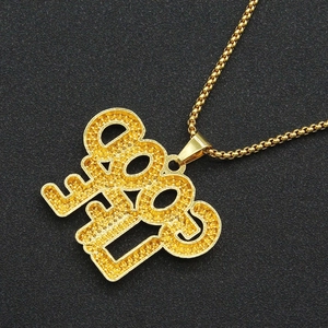 Close-up of gold 2008 number pendant with grainy texture on a hip hop style necklace