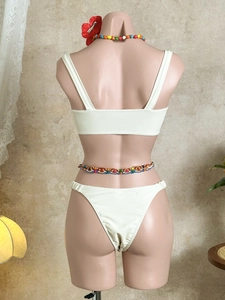 Back view of cream two-piece bikini with wide straps and high-cut thong style