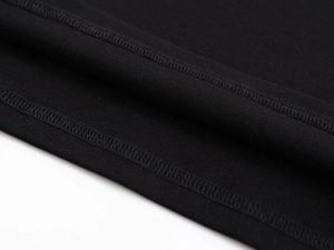 Detailed macro view of the double-stitched hem on a black athletic compression tank top