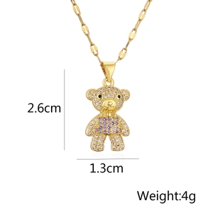 Detail showing bear pendant dimensions of 2.6cm by 1.3cm with gold and zircon inlay