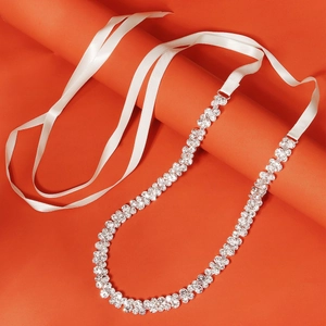 Ceinture élégante en strass avec rubans en soie blanche sur un fond orange vif