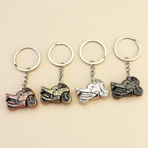 Metal motorcycle keychains in red copper, antique brass, silver, and gun black finishes