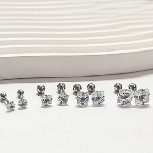 Detail of four-prong square zircon stud earrings with screw-back balls in varied sizes