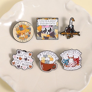 Creative stackable cats and coffee enamel pins set featuring a white ceramic display tray