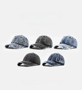 Detailed view of washed denim baseball caps with distressed edges and colorful embroidery