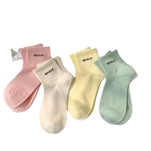 Set of four cotton mid-calf socks in pastel colors featuring embroidered SMILE lettering