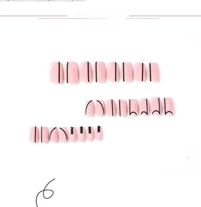 Detail of pink matte press-on nails with minimalist black geometric lines and square-oval shape