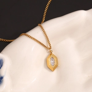 Macro view of 18K gold plated rhombus pendant with marquise cut white crystal