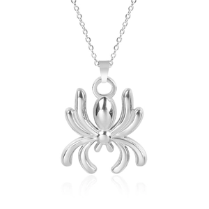 Macro view of polished silver spider pendant with fine metallic chain on white surface