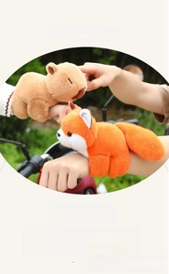 Detail of plush animal slap bracelets featuring a brown capybara and an orange fox design