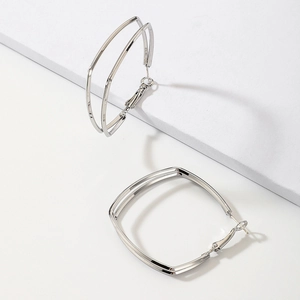 Minimalist double-layered geometric silver hoop earrings with a polished metallic finish