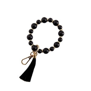 Porte-clés bracelet en perles noires avec pompons noirs et fermoir mousqueton doré
