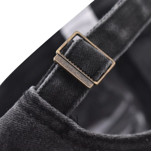 Detail of adjustable brass buckle and vintage washed cotton strap on the baseball cap