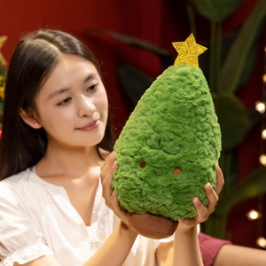 Cute green plush Christmas tree pillow with a smiling face and golden star on top