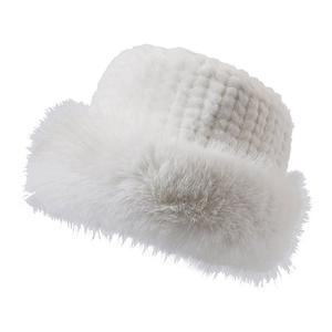 Close-up of white plush faux fur winter hat texture and soft fluffy brim detail