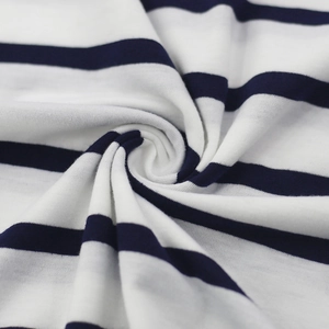Macro shot of navy blue and white striped cotton knit fabric with soft texture and drape