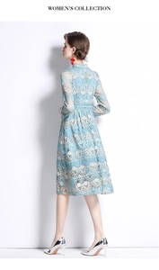 Detailed side view of light blue lace embroidered dress showing long sleeves and waist fit