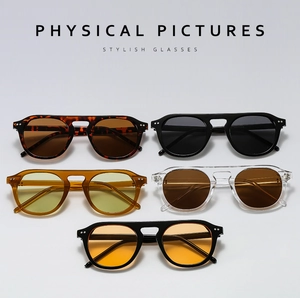 Flat lay view of retro pilot sunglasses in tortoiseshell, black, and jelly colors