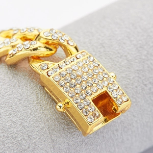 Detail of gold Cuban link chain with sparkling rhinestones and a secure clasp mechanism
