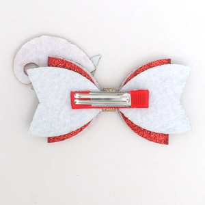Detail view of the silver metal duckbill clip and layered felt on a Christmas bow hairclip