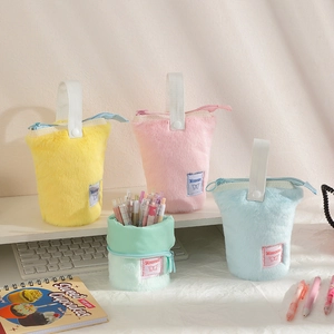 Detail of plush pencil cases in pastel colors showing soft texture and sturdy zippers