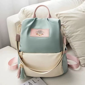 Tricolor Oxford nylon backpack in mint green and beige with decorative tassels