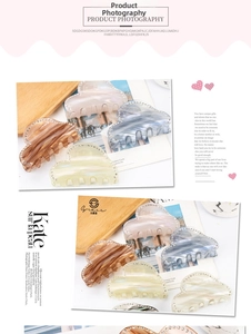 Detail of heart-shaped hair claws with rhinestones in pink, blue and beige marble finish