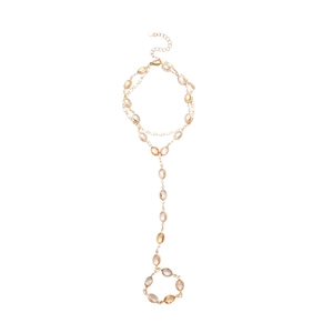 Elegant gold chain tassel bracelet with oval opalescent resin gemstones on white background