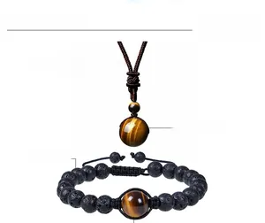 Detailed view of 16mm tiger eye pendant necklace and adjustable lava stone bracelet set