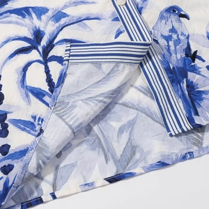 Two-piece tropical island print sleeveless top and skirt set with palm and parrot pattern