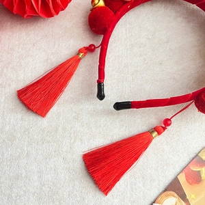 Chinese New Year red headband with long tassels, plush balls and golden bells
