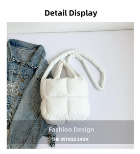 Detail view of white quilted puffer tote bag next to a light blue denim jacket