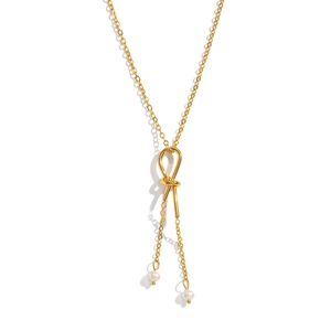 Minimalist gold knot sweater necklace featuring freshwater pearls and elegant tassels
