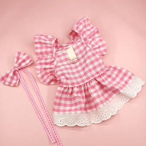 Detail of pink plaid dog dress with lace trim and metal D-ring for leash attachment