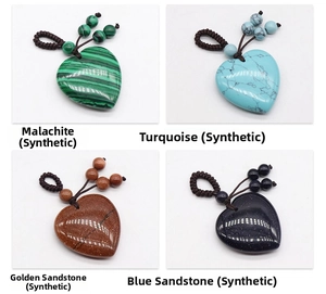 Detail view of synthetic malachite, turquoise, and goldstone heart-shaped pendants