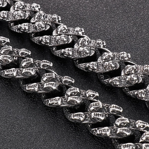 Macro detail of antique silver skull relief links on a vintage titanium steel chain bracelet