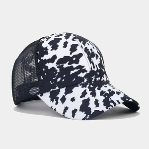 Detail of cow print baseball cap featuring breathable mesh back and curved brim design