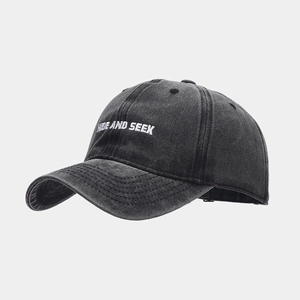 Detailed close-up of HIDE AND SEEK 3D embroidery on washed cotton baseball cap