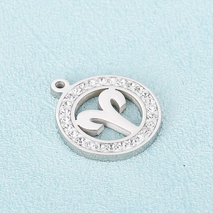 Macro view of silver Aries zodiac pendant with crystal stones and metal finish