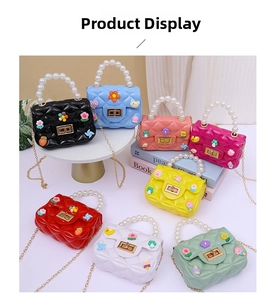 Detailed view of mini jelly crossbody bags with pearl handles in eight vibrant colors