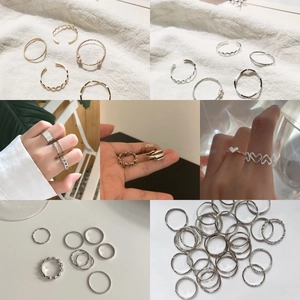 Detail shot of various heart shaped and minimalist gold and silver rings for women