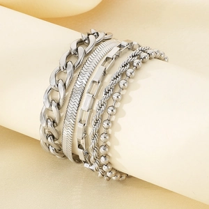 Detail of five silver multilayer bracelets including Cuban, snake, and twisted link chains