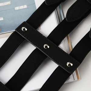 Detail of punk style black elastic waist belt featuring silver cone metal rivets and leather