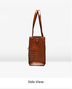 Side view of brown crocodile embossed tote bag with silver D-ring and strap details