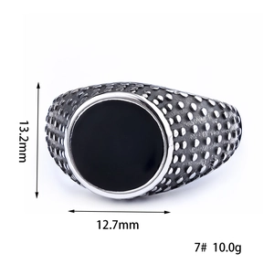Macro view of vintage stainless steel signet ring with black gem and textured side detail