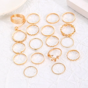 Flat lay of 16-piece gold alloy rings set featuring celestial and bohemian textured designs