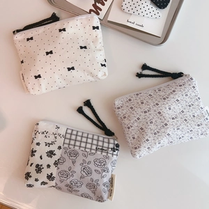 Detailed view of floral cotton mini pouches with tassels and simple wish woven labels